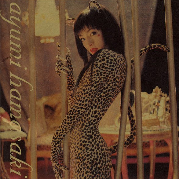 Album cover featuring a person in a leopard print outfit with cat ears and tail, set against a vintage-style background.