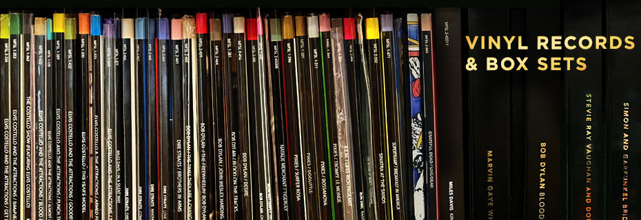 Vinyl records neatly lined up on a shelf, representing Audio Exchange's wide selection of music genres available in vinyl format.