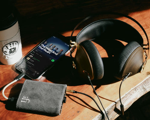 A lifestyle picture of a portable headphone amplifier