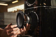 McIntosh XRT1.1K loudspeaker showing the suspended line array and Piano Black bass enclosure