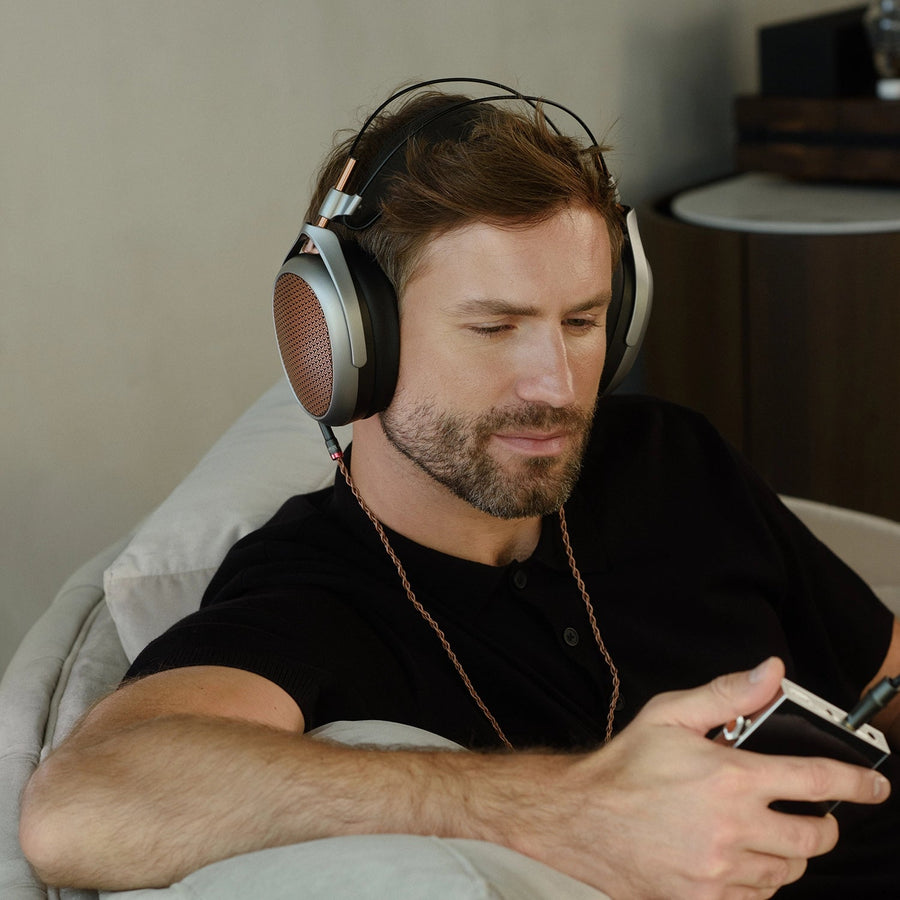 Listener wearing Meze POET open-back headphones