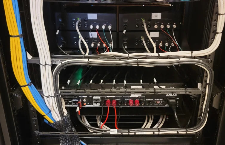 Close-up of a server rack with various cables and equipment.