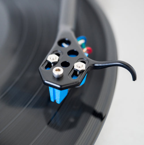 Image is a close up of a cartridge on a vinyl record.